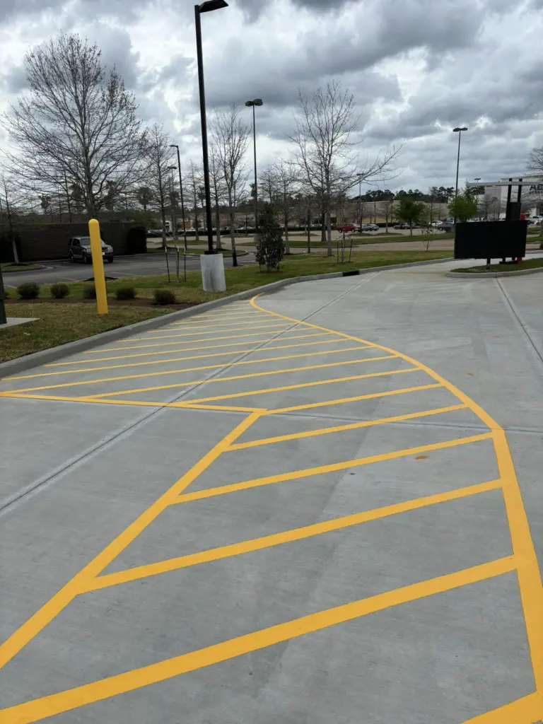 Curved yellow chevron hatch at a drive-thru exit