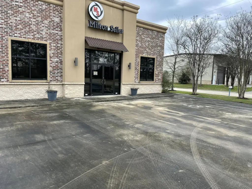 Storefront parking lot before pressure washing